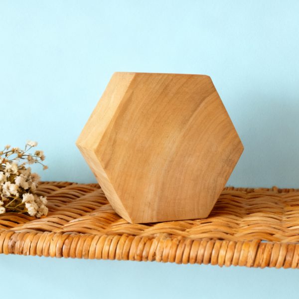 Handcrafted camphor wood hexagonal decorations add charm to living spaces with their bohemian minimalist style.